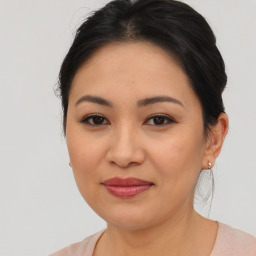 Joyful asian young-adult female with medium  brown hair and brown eyes