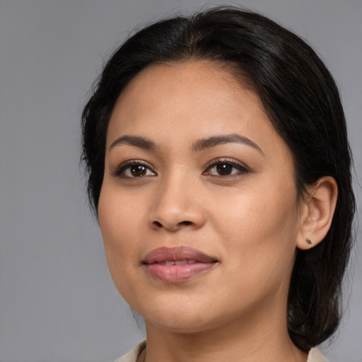 Joyful latino young-adult female with medium  brown hair and brown eyes