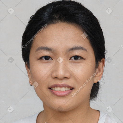 Joyful asian young-adult female with short  black hair and brown eyes