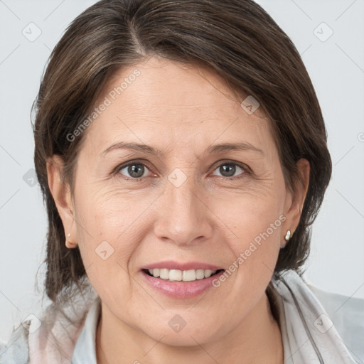 Joyful white adult female with medium  brown hair and grey eyes