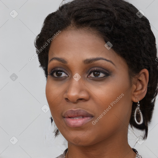 Joyful black young-adult female with long  black hair and brown eyes