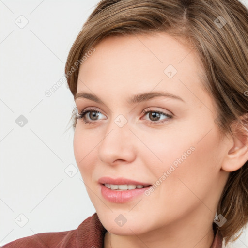 Joyful white young-adult female with medium  brown hair and blue eyes