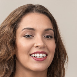 Joyful white young-adult female with long  brown hair and green eyes