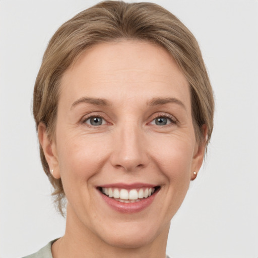 Joyful white adult female with short  brown hair and grey eyes