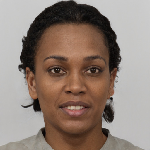 Joyful black young-adult female with short  brown hair and brown eyes