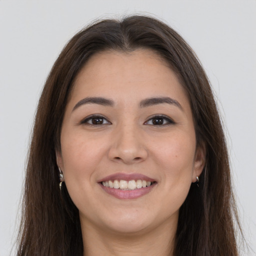 Joyful white young-adult female with long  brown hair and brown eyes