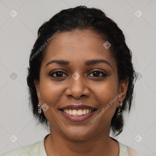 Joyful black young-adult female with short  brown hair and brown eyes