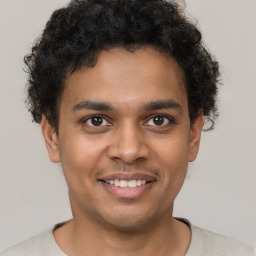 Joyful latino young-adult male with short  brown hair and brown eyes