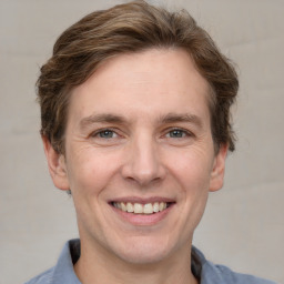 Joyful white adult male with short  brown hair and grey eyes