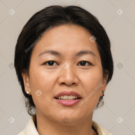 Joyful asian adult female with medium  brown hair and brown eyes