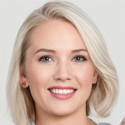 Joyful white young-adult female with long  brown hair and blue eyes