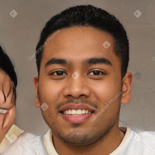 Joyful latino young-adult male with short  black hair and brown eyes