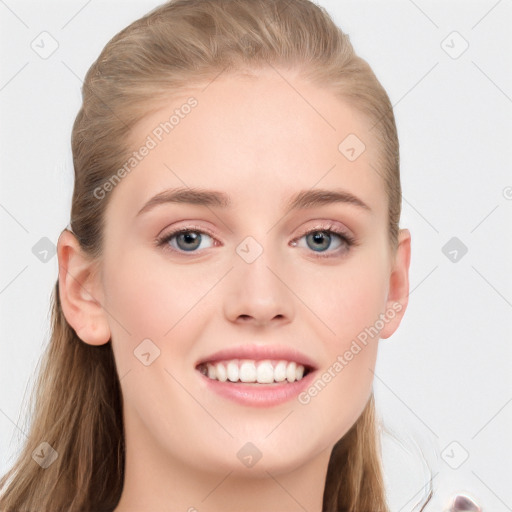 Joyful white young-adult female with long  brown hair and blue eyes