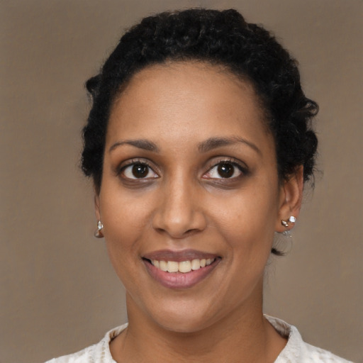 Joyful black young-adult female with short  brown hair and brown eyes