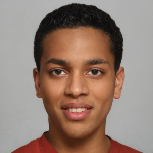 Joyful black young-adult male with short  black hair and brown eyes