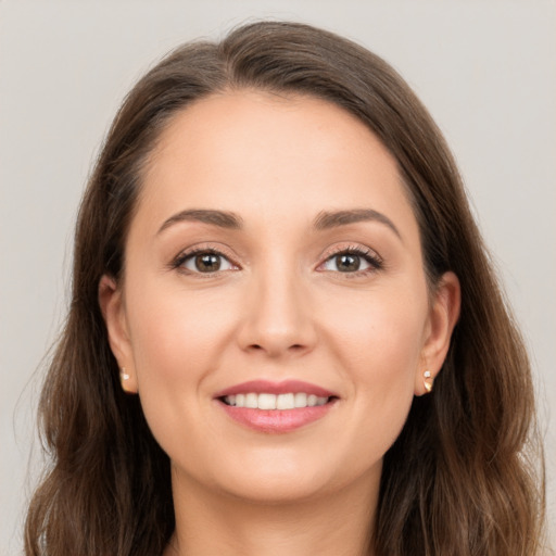 Joyful white young-adult female with long  brown hair and brown eyes