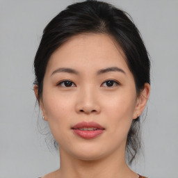 Joyful asian young-adult female with medium  brown hair and brown eyes