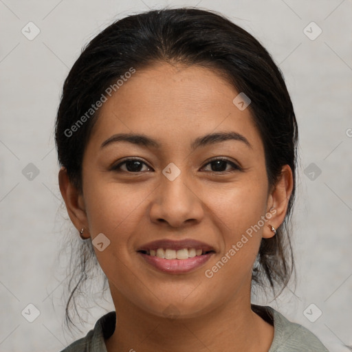 Joyful latino young-adult female with medium  brown hair and brown eyes