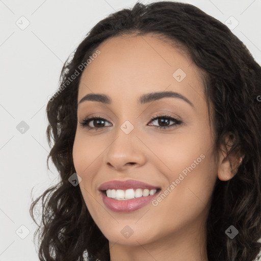 Joyful white young-adult female with long  black hair and brown eyes