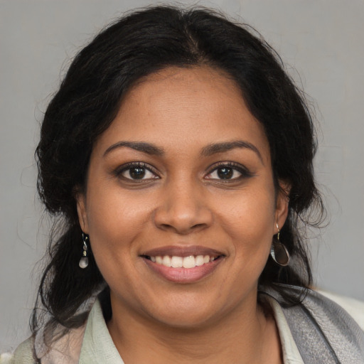 Joyful black young-adult female with medium  brown hair and brown eyes