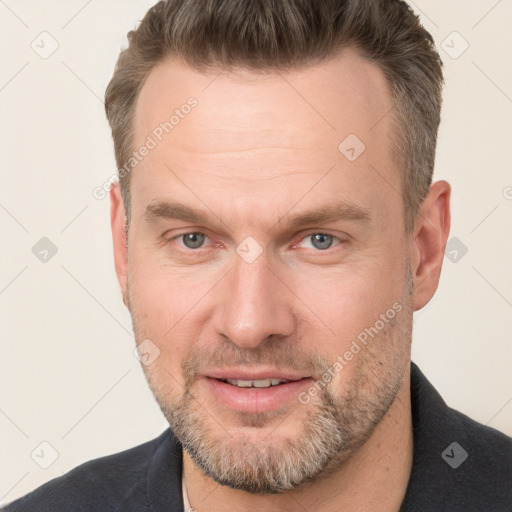 Joyful white adult male with short  brown hair and grey eyes