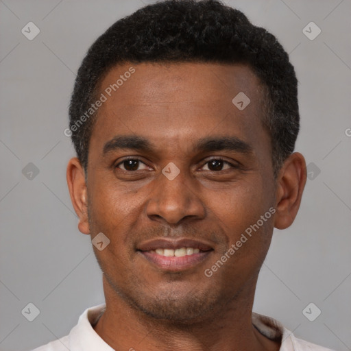 Joyful black young-adult male with short  brown hair and brown eyes
