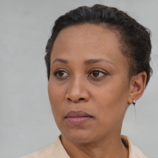 Joyful black adult female with short  brown hair and brown eyes