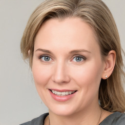 Joyful white young-adult female with medium  brown hair and blue eyes