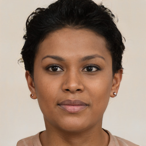 Joyful black young-adult female with short  brown hair and brown eyes