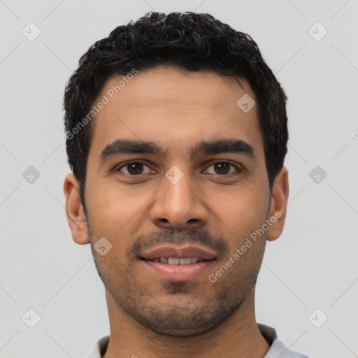 Joyful latino young-adult male with short  black hair and brown eyes