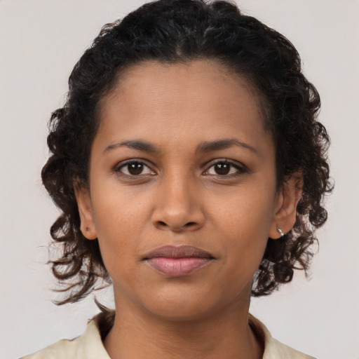 Joyful black young-adult female with medium  brown hair and brown eyes