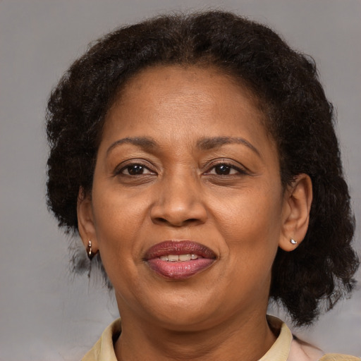 Joyful black adult female with medium  brown hair and brown eyes
