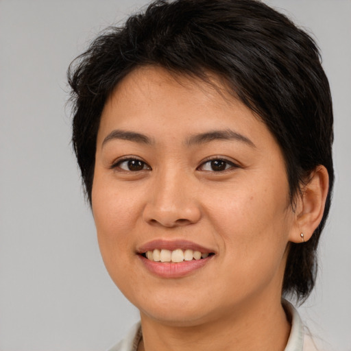Joyful asian young-adult female with medium  brown hair and brown eyes