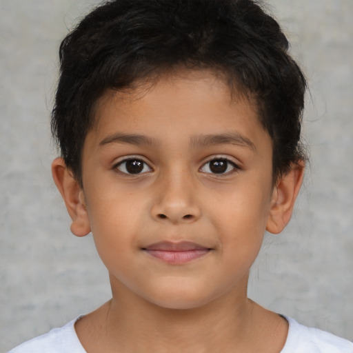 Joyful latino child male with short  brown hair and brown eyes