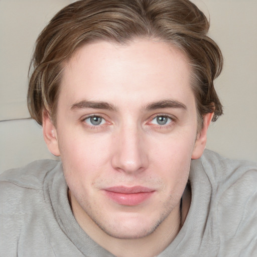 Joyful white young-adult male with medium  brown hair and grey eyes