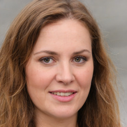 Joyful white young-adult female with long  brown hair and green eyes