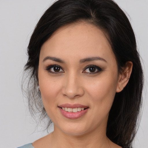 Joyful latino young-adult female with long  brown hair and brown eyes