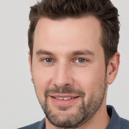 Joyful white young-adult male with short  brown hair and brown eyes