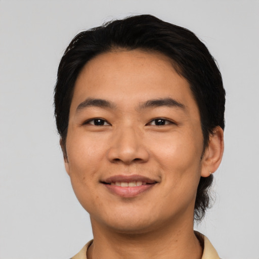 Joyful asian young-adult male with short  black hair and brown eyes