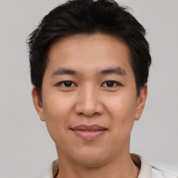 Joyful asian young-adult male with short  brown hair and brown eyes