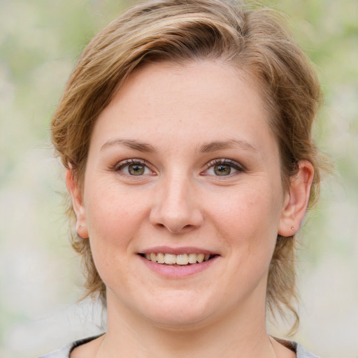 Joyful white young-adult female with medium  brown hair and blue eyes