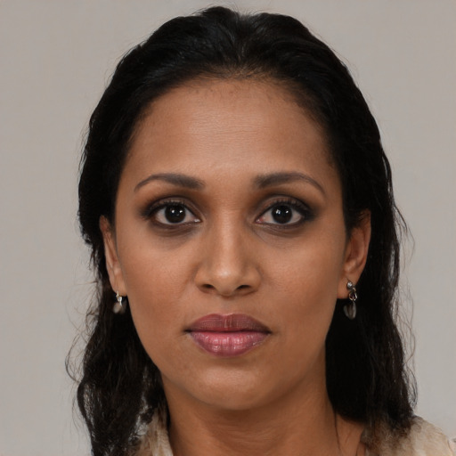 Joyful black adult female with medium  black hair and brown eyes
