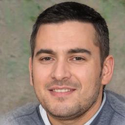 Joyful white adult male with short  brown hair and brown eyes