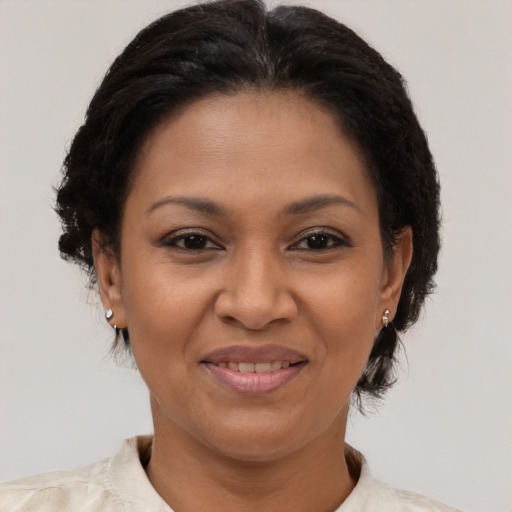 Joyful latino adult female with medium  brown hair and brown eyes