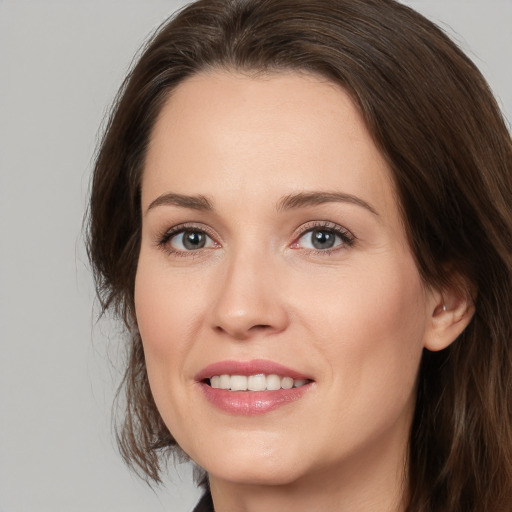 Joyful white young-adult female with medium  brown hair and brown eyes