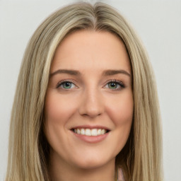 Joyful white young-adult female with long  brown hair and green eyes