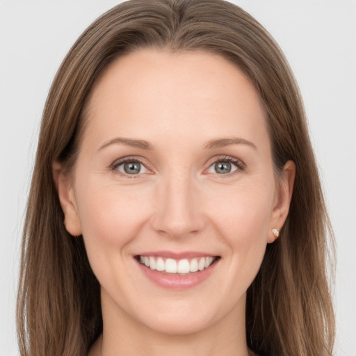 Joyful white young-adult female with long  brown hair and grey eyes