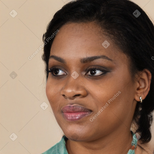 Joyful black young-adult female with long  black hair and brown eyes