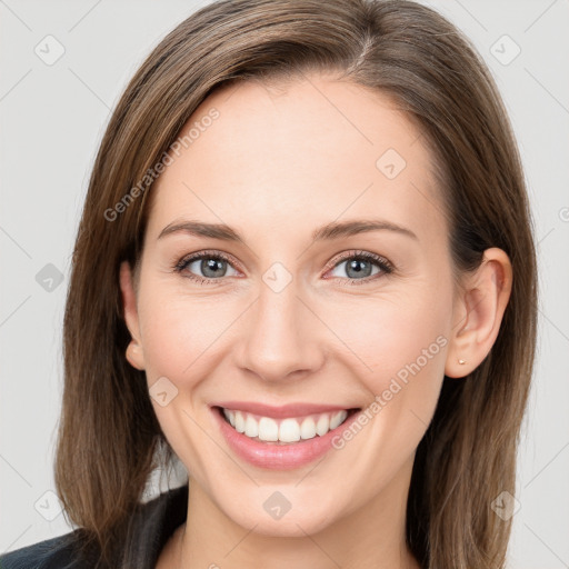 Joyful white young-adult female with long  brown hair and grey eyes