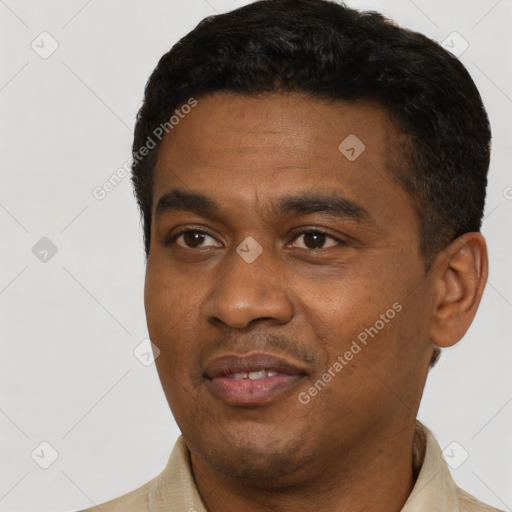 Joyful latino young-adult male with short  black hair and brown eyes